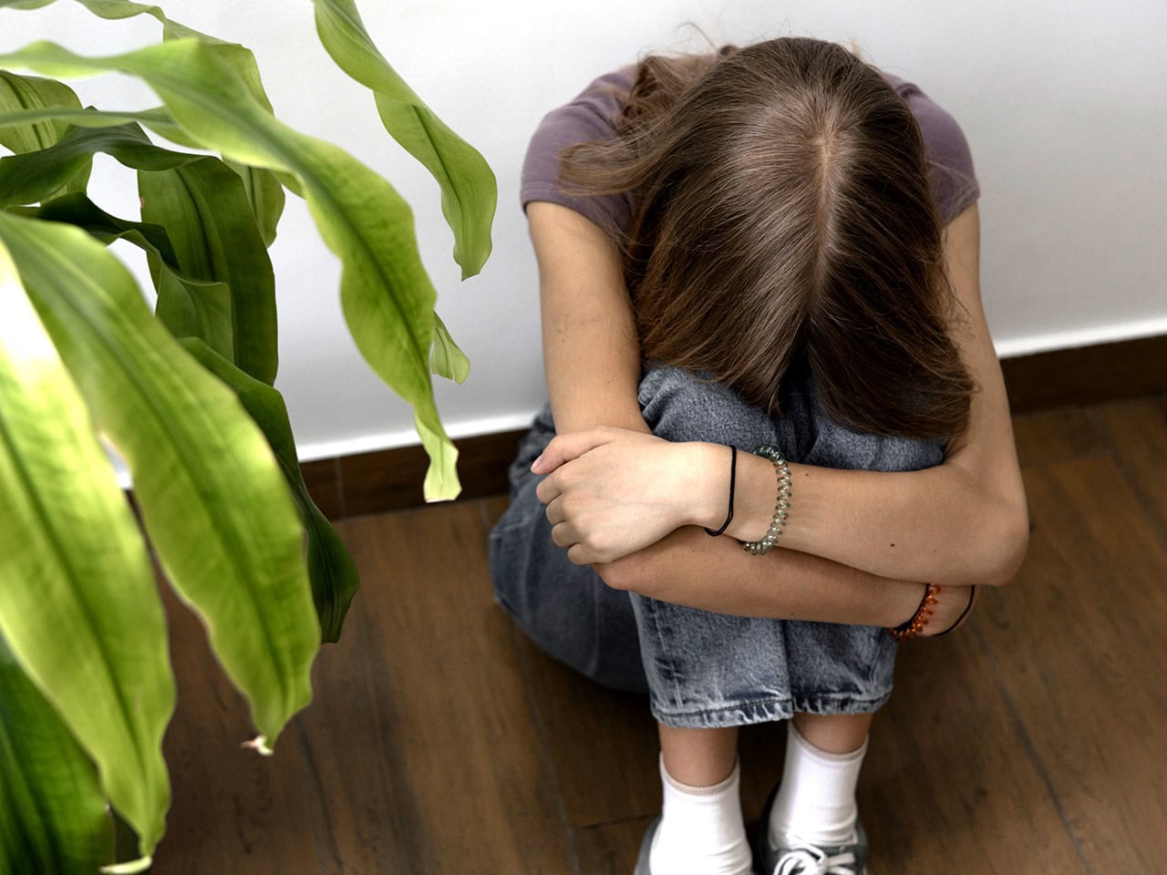 Young teenager depressed and sitting on floor