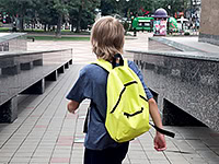 Young school student with backpack