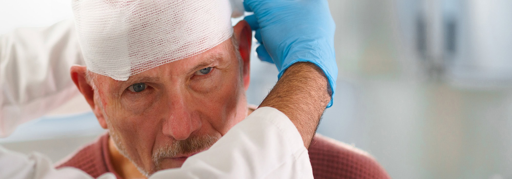 man getting medical attention getting his head bandaged