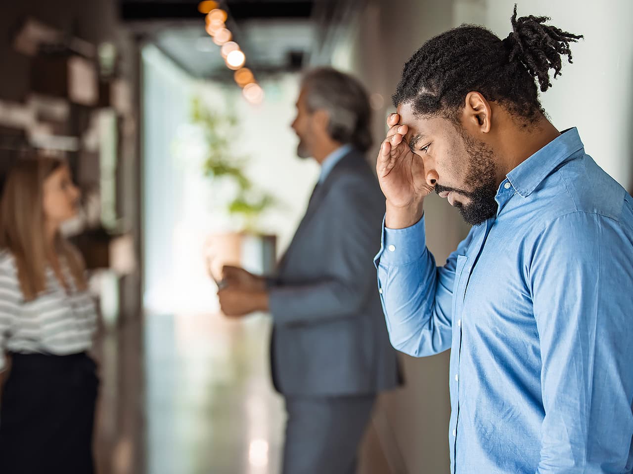 Man holding his head, stressed from work