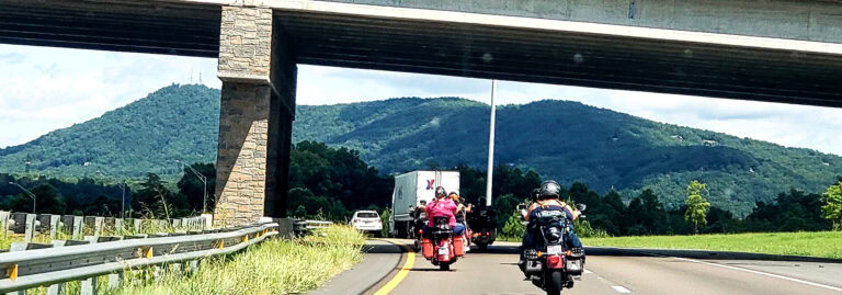 motorcyclists riding through an underpass