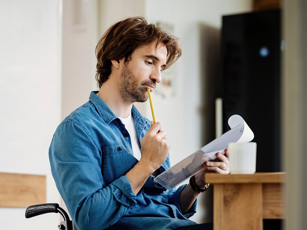Seated man filling out disability application
