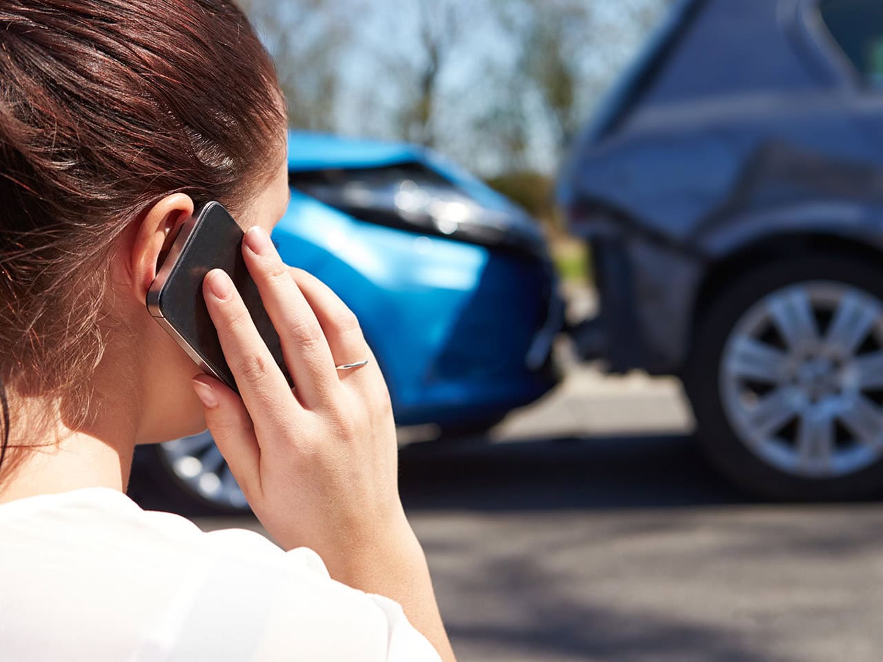 Woman on phone with insurance after car accident