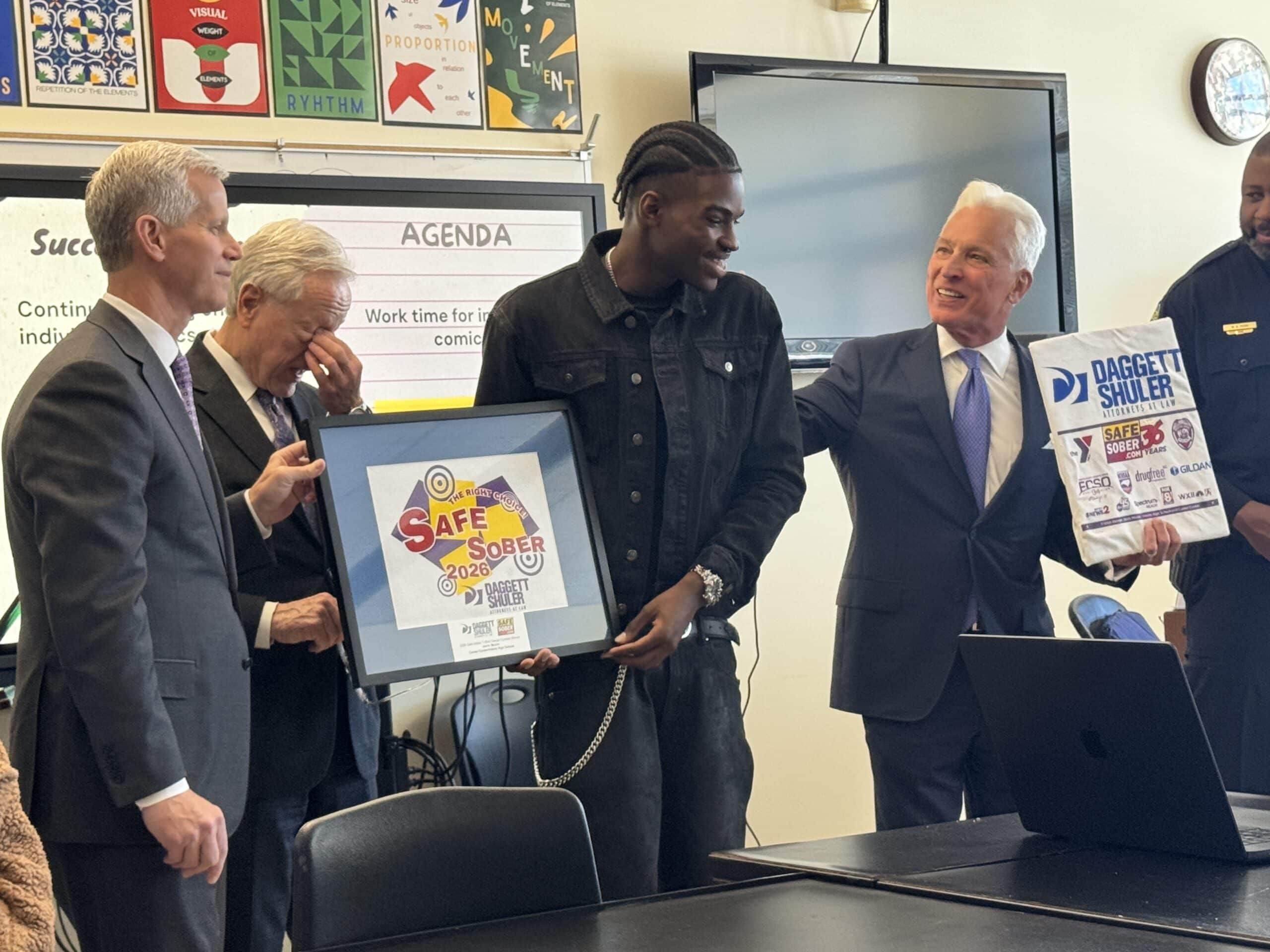 david daggett and griff shuler with jerrin, the 2026 t-shirt design winner