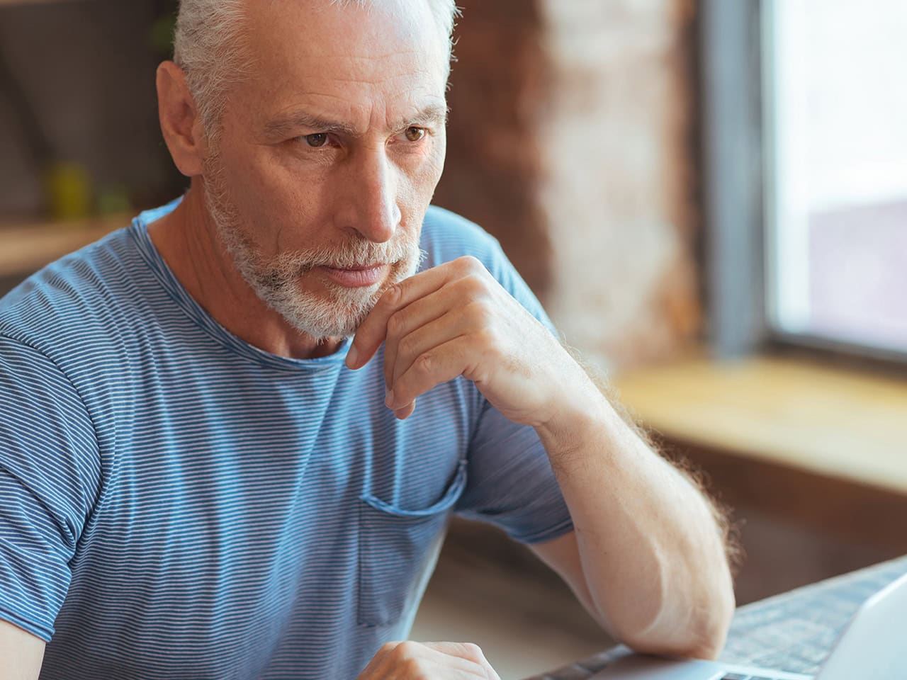 Middle aged man with beard using computer