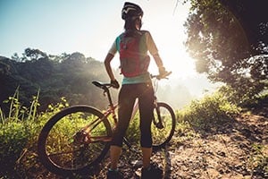 woman-with-bike-on-trail